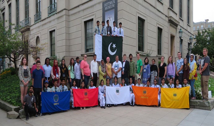 Group of students holding Students in the Learning Streams International program holding Flags of Unity, Faith, Discipline and Tolerance