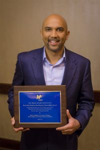 Photo of Mark Joseph holding plaque