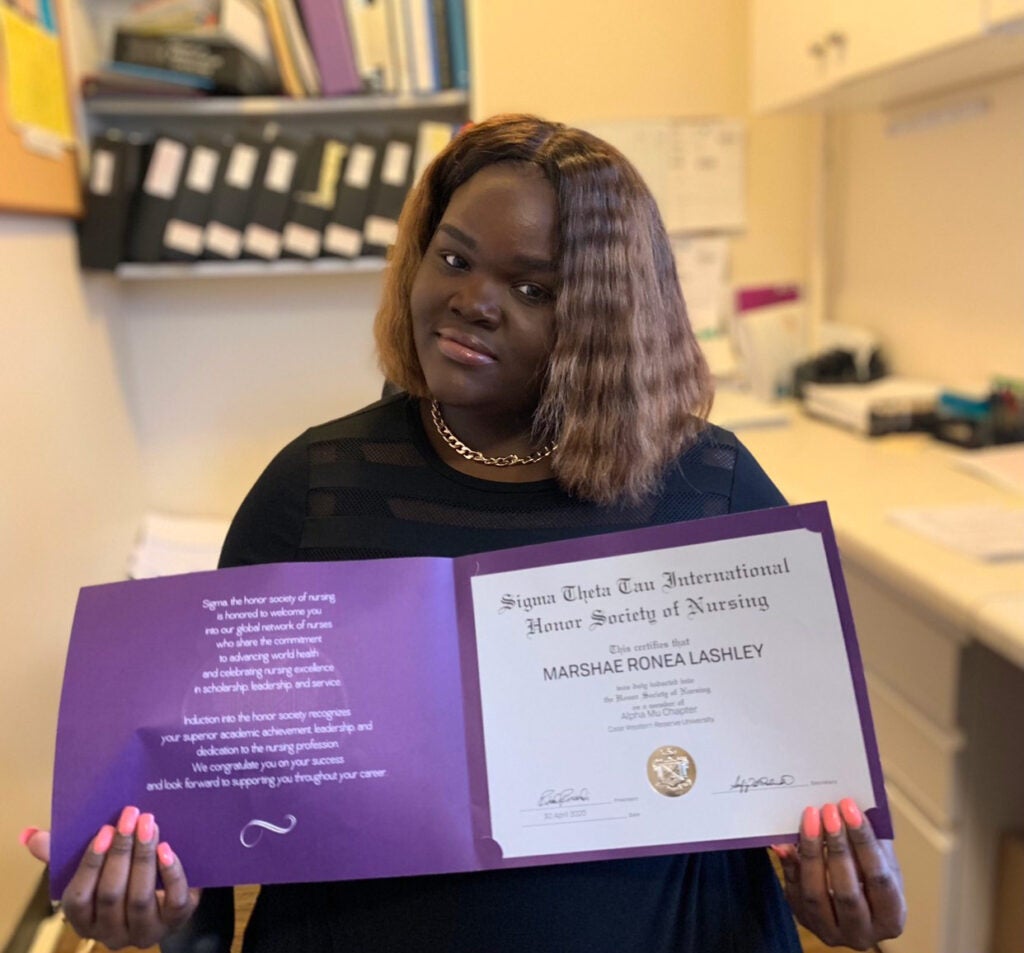 Photo of Marshae Lashley holding a certificate