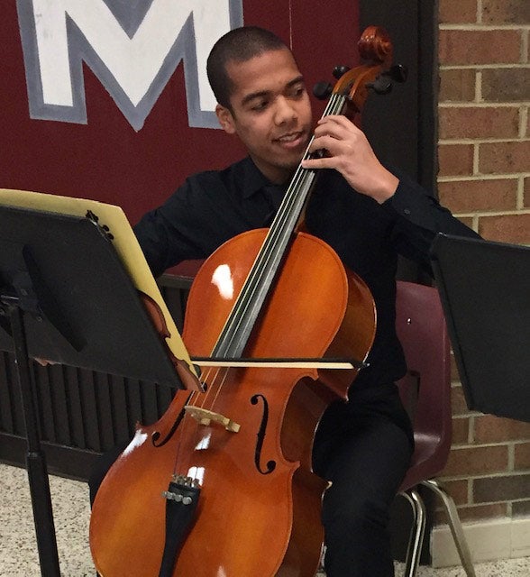 Photo of Micco Daniels playing the cello