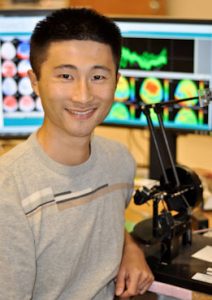 Michael Fu of CWRU stands in front of computers
