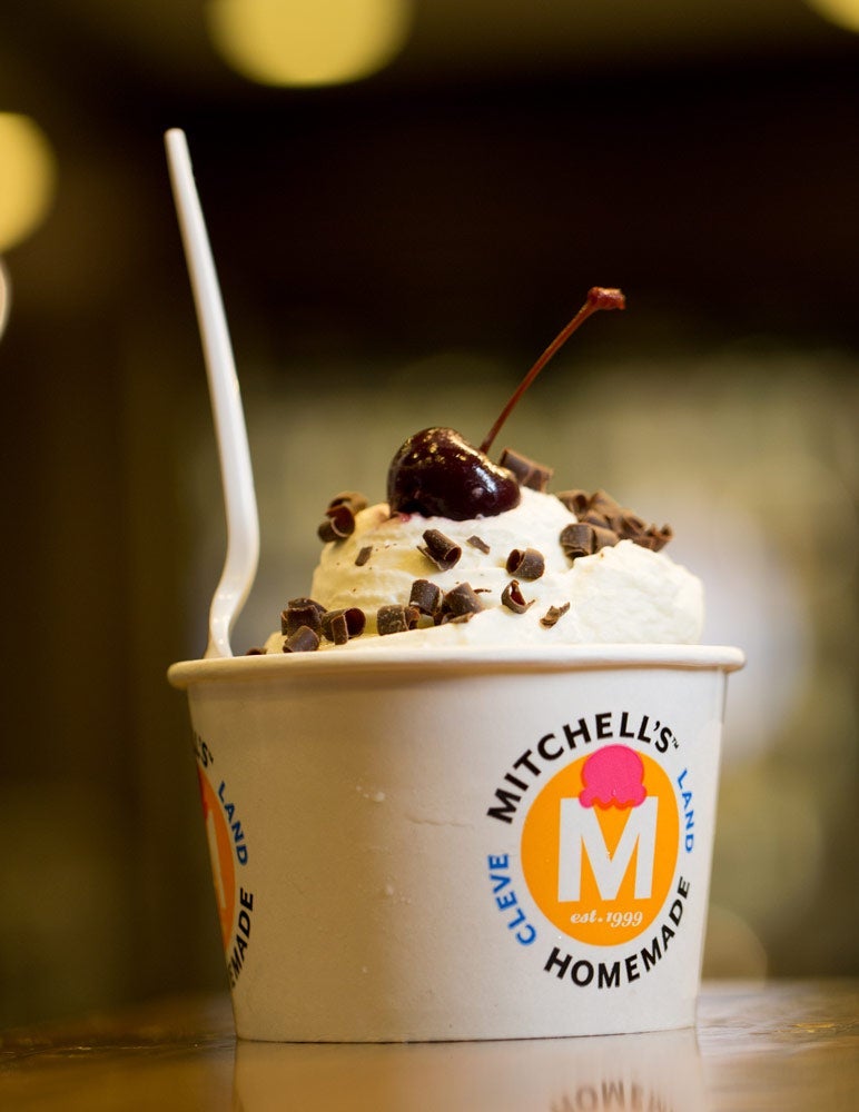 Photo of a cup of Mitchell's ice cream with a cherry and chocolate shavings on top