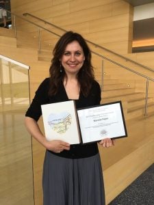 Photo of Narcisz Fejes holding certificate