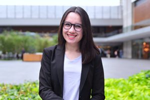 Olivia Ortega sitting outside on campus