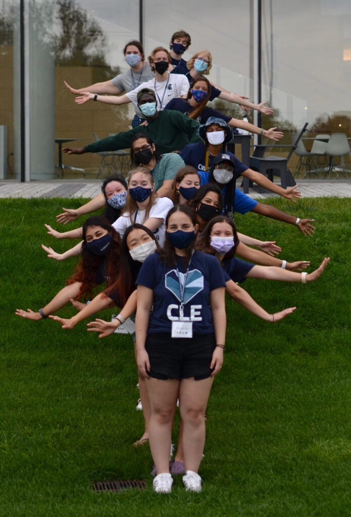 Photo of CWRU orientation leaders standing in a line with their arms out