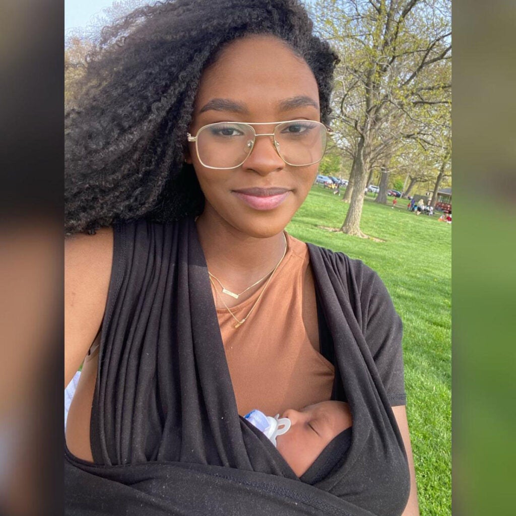 Photo of a woman outside with her baby in a baby wrap carrier