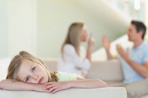 parents arguing in background with child in foreground