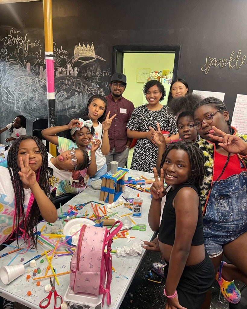 Photo of Queen IAM participants, graduate students and Dani Jones during a bridge-building competition