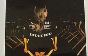 Rebekah Camp sitting in a director's chair