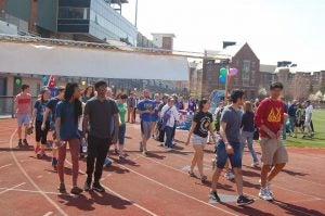 students walk around the track at Relay for Life 2015