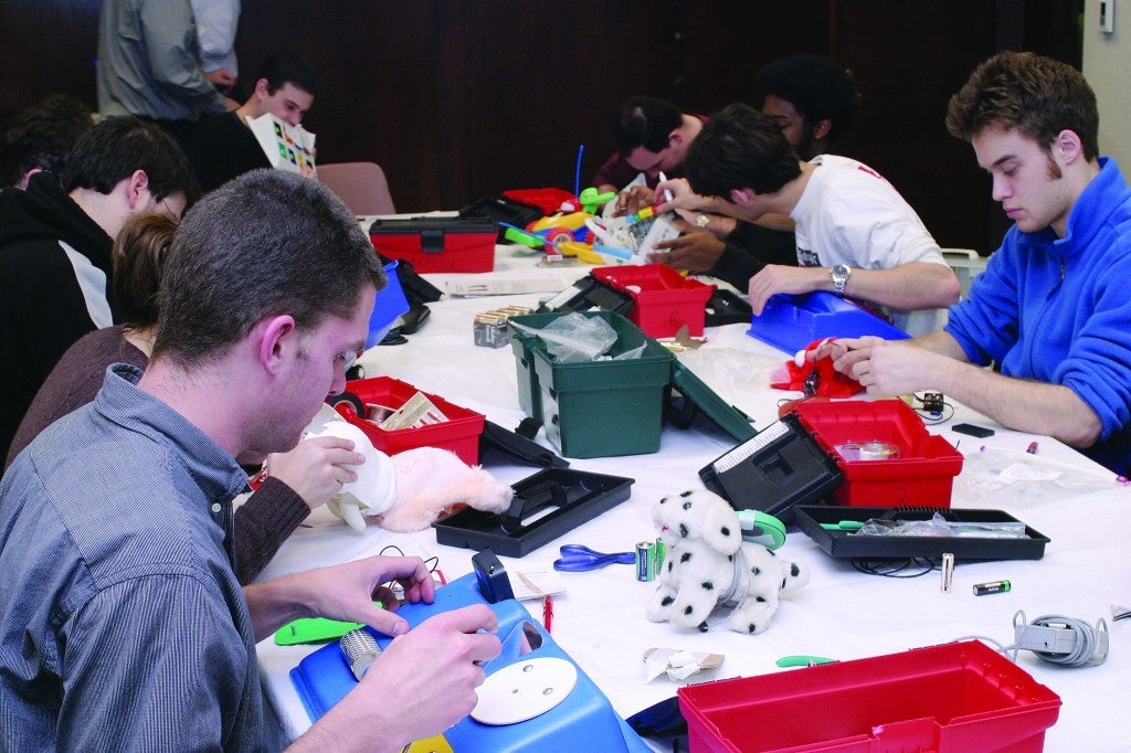 CWRU students repairing toys at replay for kids