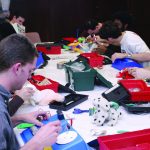 CWRU students repairing toys at replay for kids