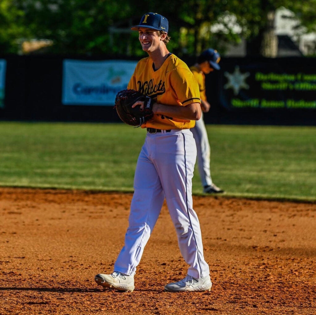 Photo of Robert Boyce walking on the baseball field during a game his senior year of high school