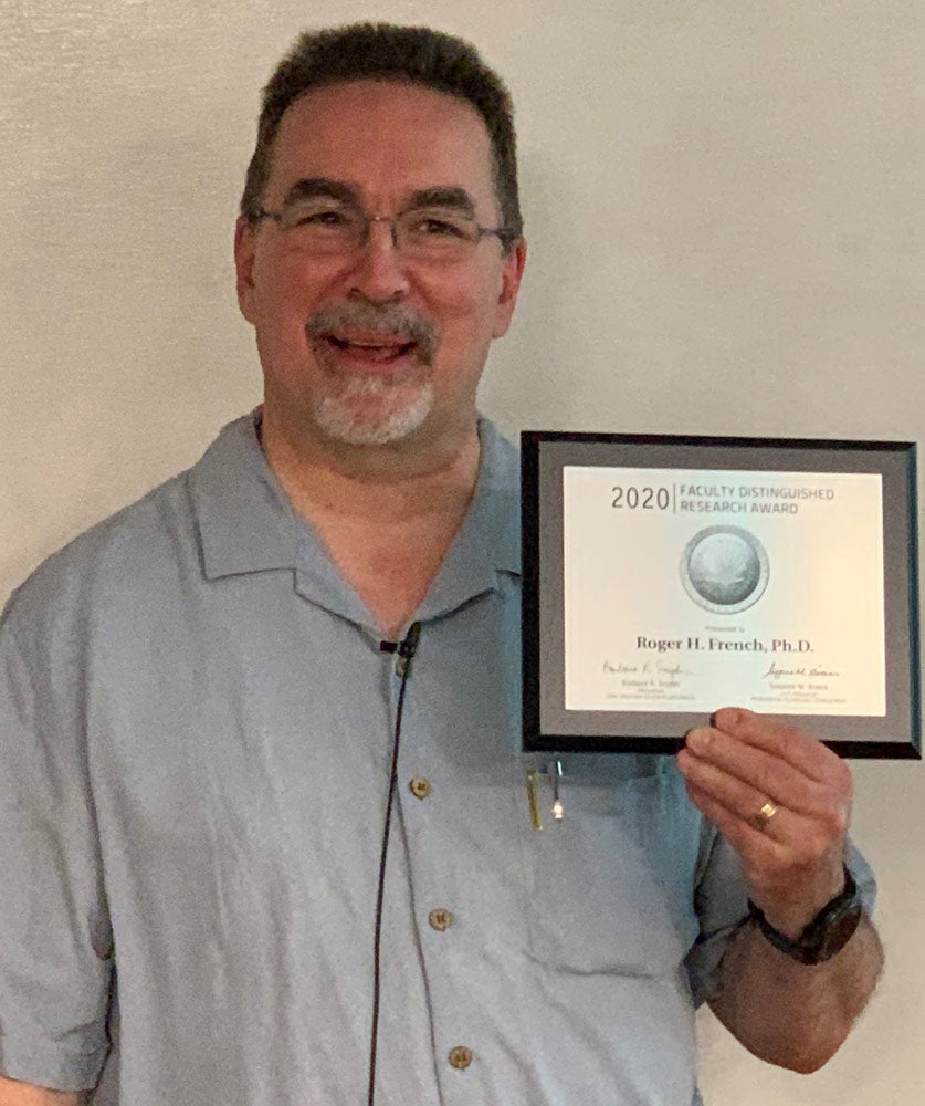 Photo of Roger French holding an award plaque