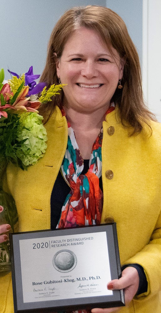 Photo of Rose Gubitosi-Klug holding award plaque