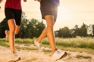 two people running in park