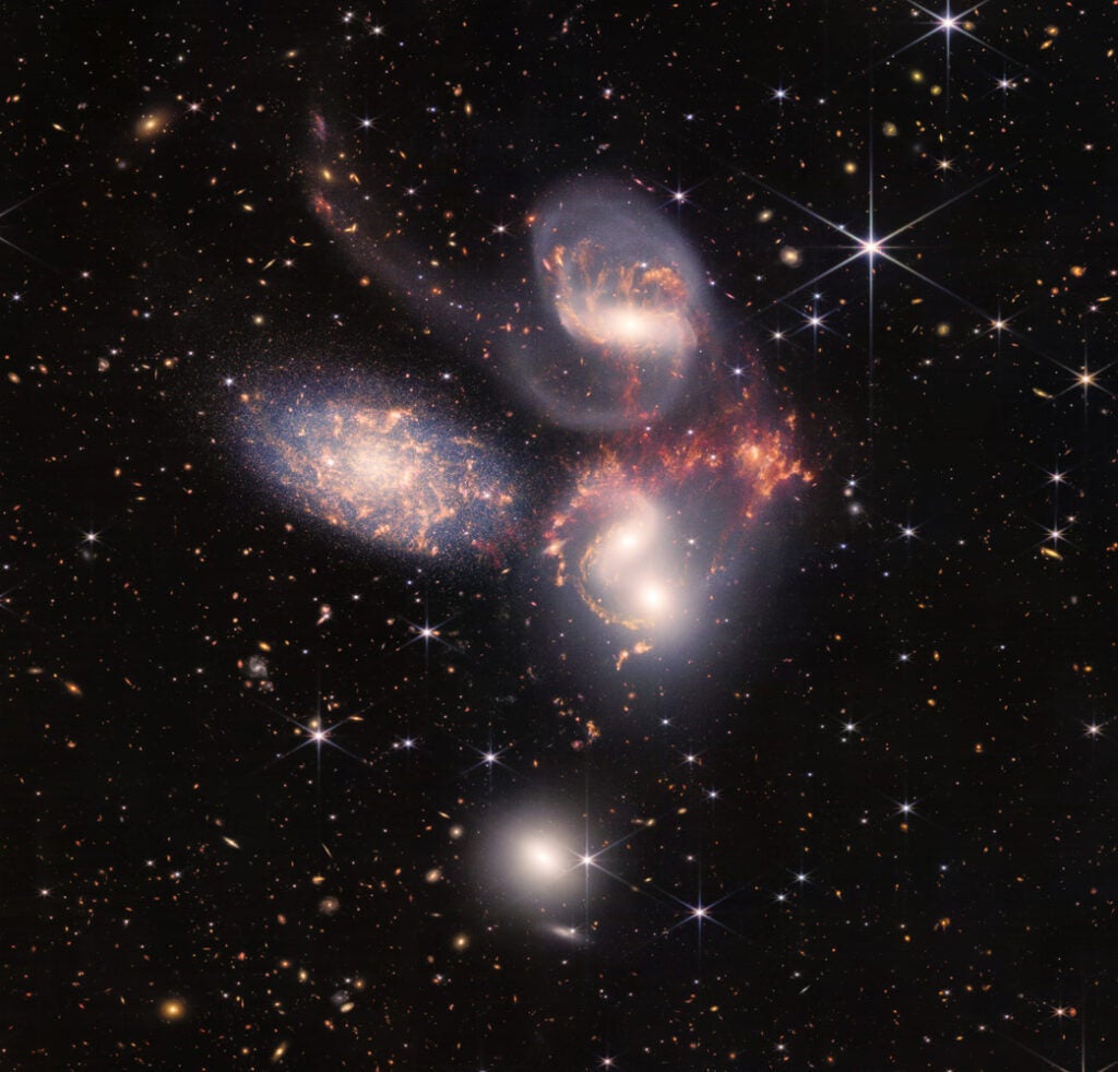 Photo of smooth whitish light in the galaxies and patchy yellow/orange light