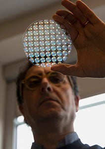 photo of Giuseppe Strangi viewing a metalens