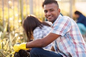 Student volunteering to clean up a park