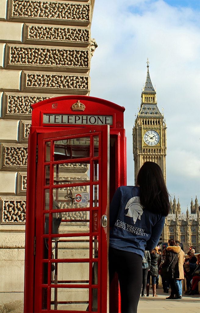 CWRU student looks at Big Ben from red phone booth in London