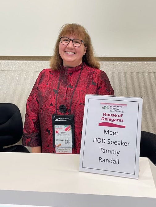 Photo of Tamara Randall posing for a photo during a speaking event