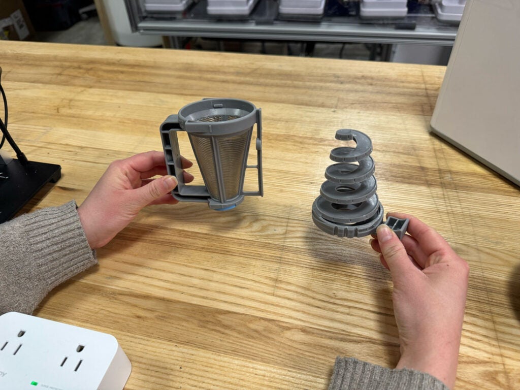 Photo of someone holding the two-part VORTX