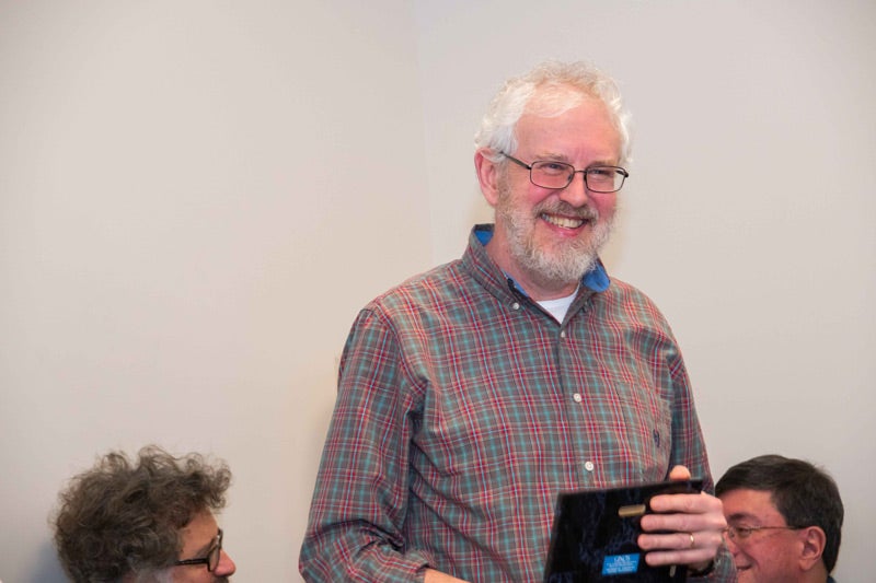 Photo of Walter Lambrecht holding Faculty Distinguished Research Award plaque