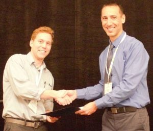 William Huddleston shakes hands with award presenter