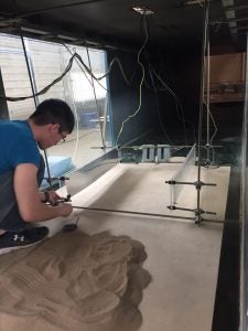 Andrew Wang sets up an experiment in the wind tunnel.