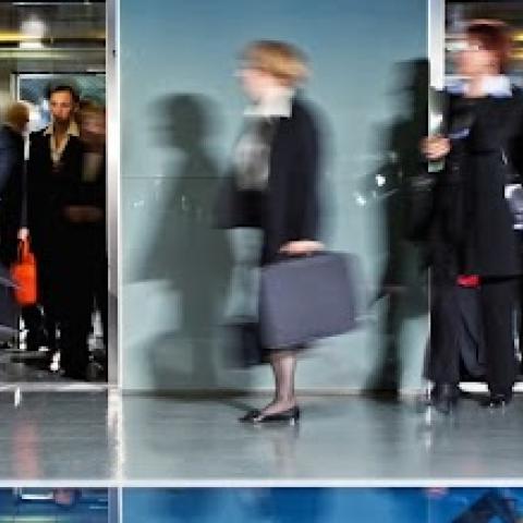 Business people walking through office.