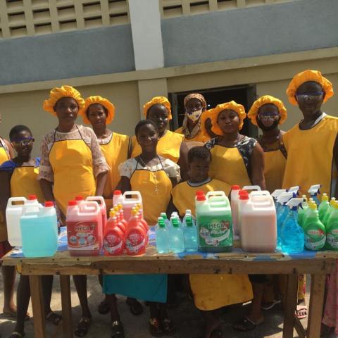 An image of a group of girls standing behind a table.