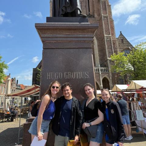 Standing in front of the famed Statute of Hugo Grotius, the Father of International Law, in The Netherlands, from Left to right: Kaylara Benfield, Oliber Bates, Teresa Lebowitz and Maria Blough