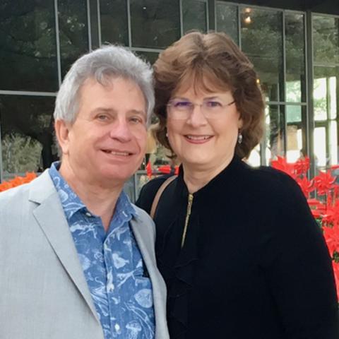 Ed and Joyce Lehotsky pictured together outside standing in front of flowers