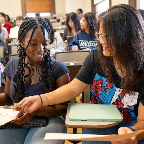 Photo of two students interacting in a classroom