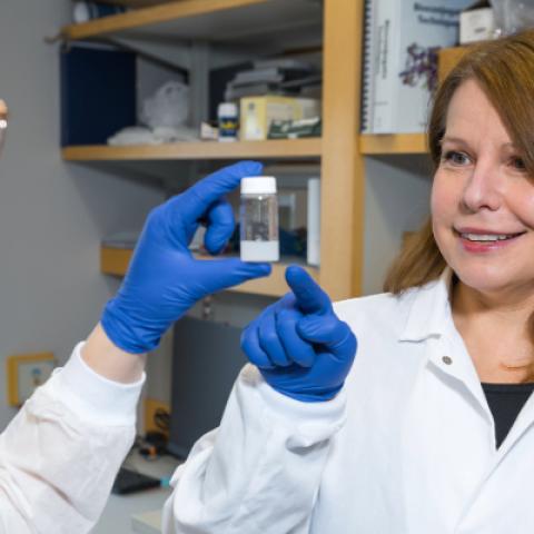 Agata Exner looking at materials in a lab with a student