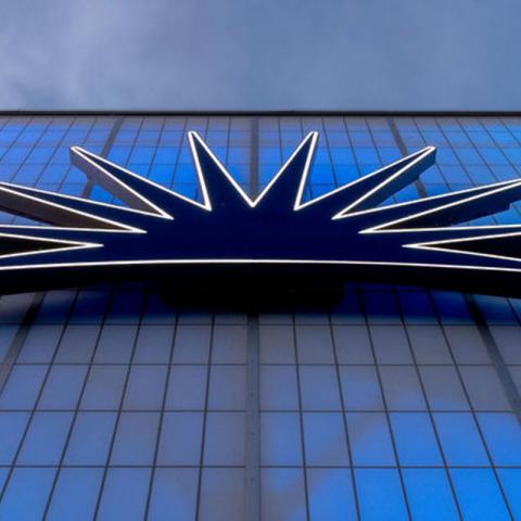 Photo of the light-up CWRU logo on the back of a campus building