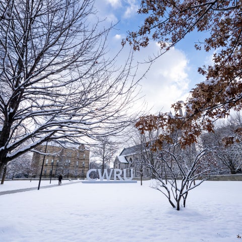 C-W-R-U letters sign covered in snow alongside the Binary Walkway.