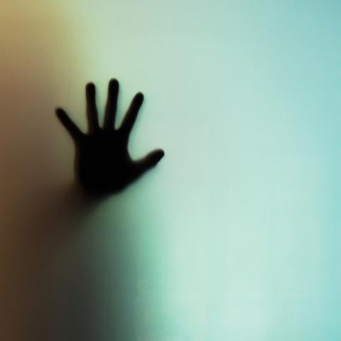 hand up against a window
