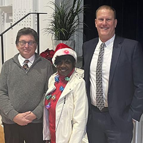 Fred Peck, Arlene Williams and Dean Tufts pose for a photo at the campus planning and facilities management holiday party