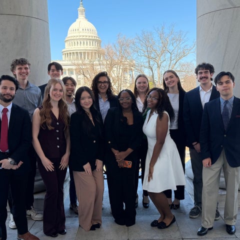 Participants of the inaugural “Washington, D.C. Trek: Exploring the Political Ecosystem and Career Paths” course pose for a group photo in front of the United States Capitol building.
