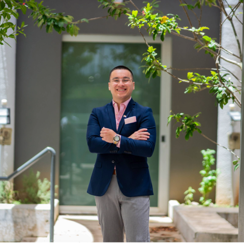 Osvaldo standing outside with his arms crossed
