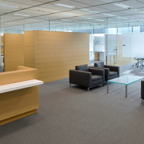 Marian K. Shaughnessy Nurse Leadership Academy lobby with brown desk and black couches.