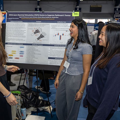 Photo of students presenting a poster at Intersections in fall 2025