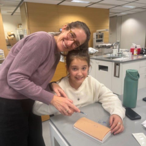Hedy Leiter practices sutures with a child