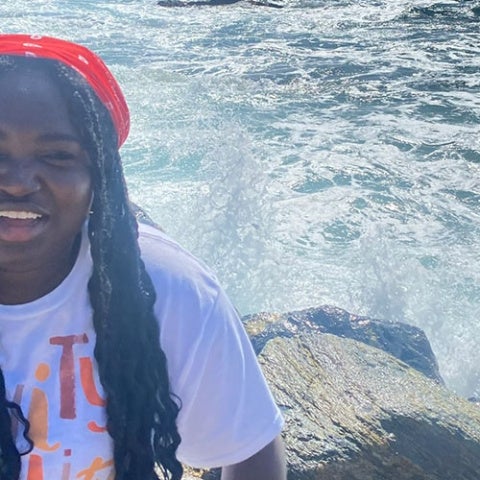 Ruth Boampong poses for a photo in front of a body of water