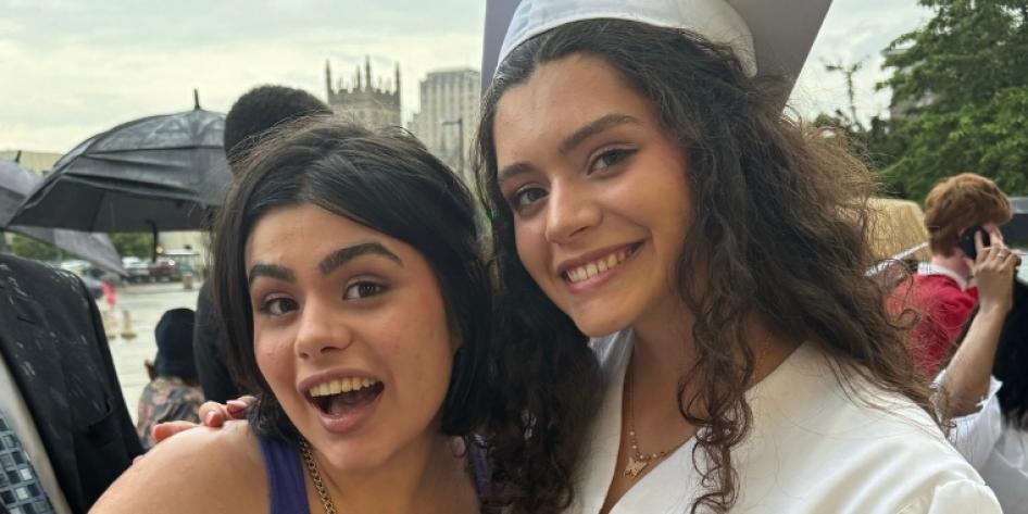 Childhood photo of Isabela and Maya Carroll during a graduation
