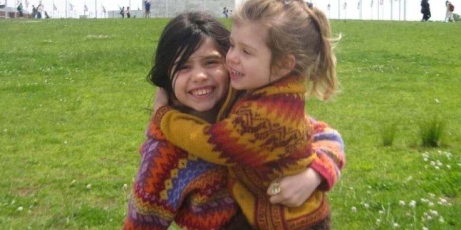 Childhood photo of Isabela and Maya Carroll hugging
