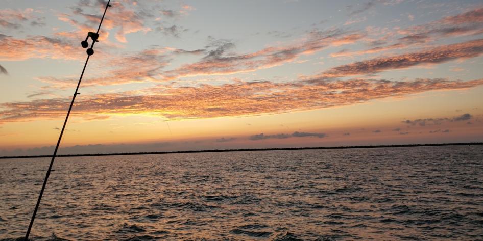 The calm of Lake Erie captured while casting a fishing line at sunset. Photo by Juan Jeffrey.