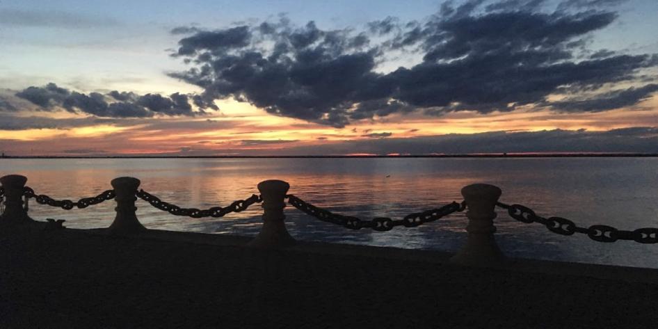 Golden hues stretch across the horizon in a classic Lake Erie sunset. Photo by Lex Ehrenschwender.