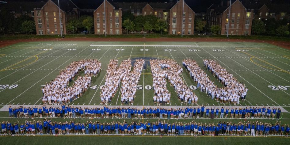 The Class of 2029 shows off their school spirit with a CWRU letters photo on DiSanto Field during Discover Week.